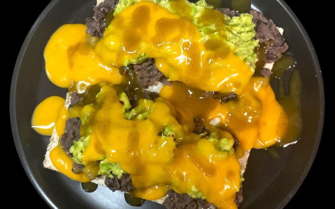 Refried Black Beans with Guacamole on Rye Crackers